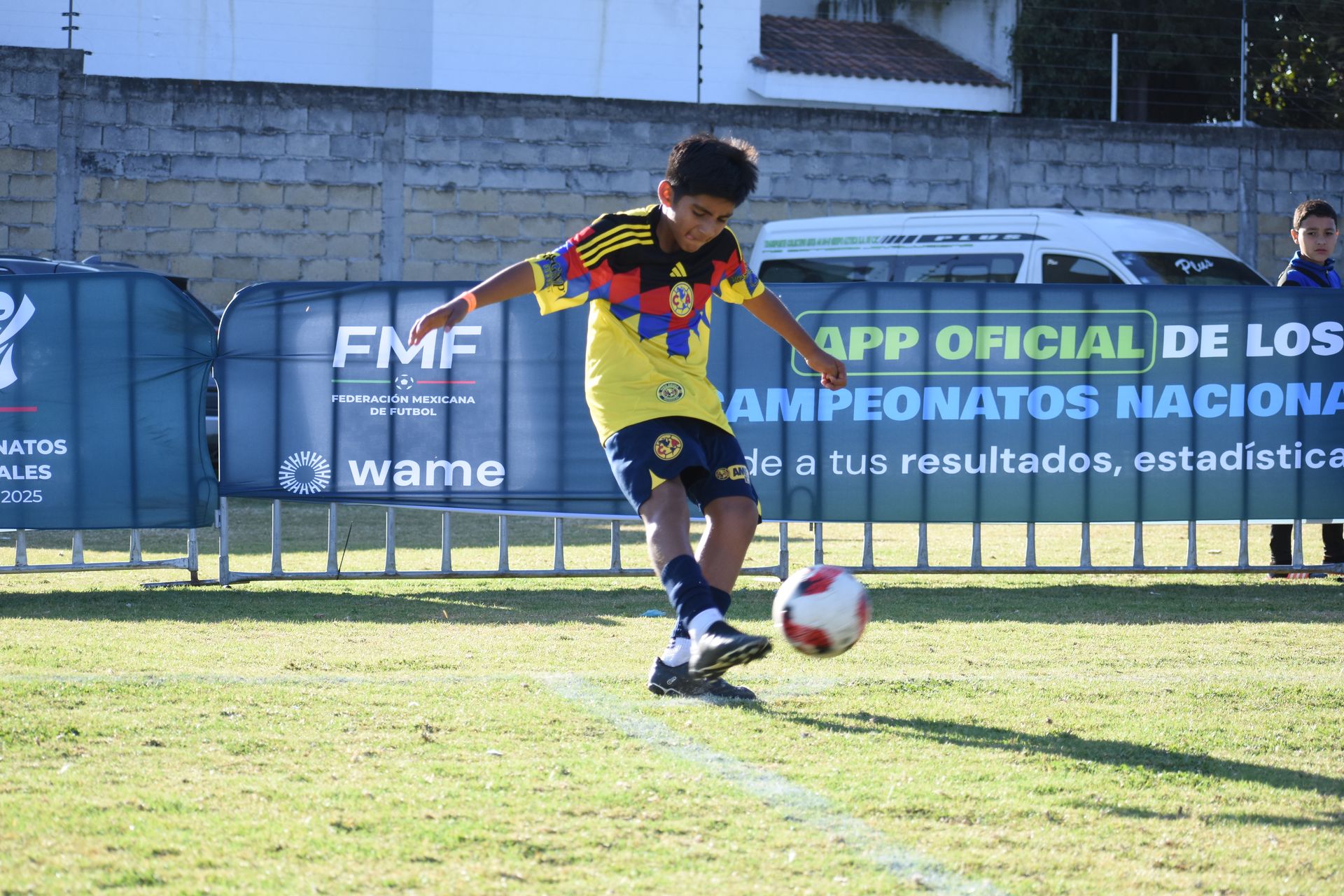 A player striking the ball on a bright training day