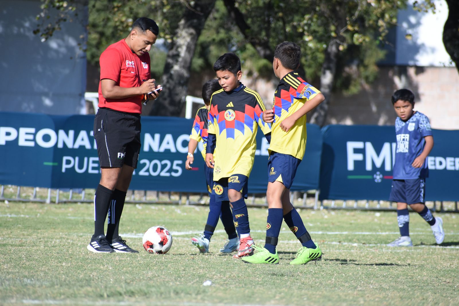 A coach guiding young players during a session