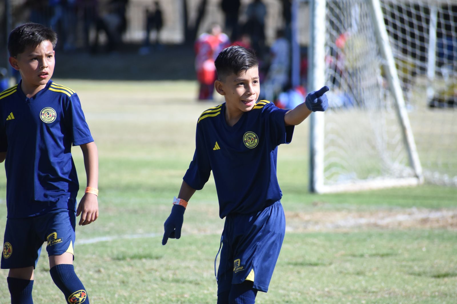 A young player smiling and pointing after a play